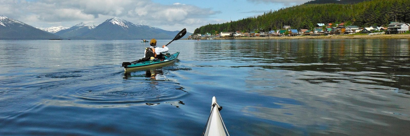 Image of kayakers on the water at Tenakee Springs, Alaska