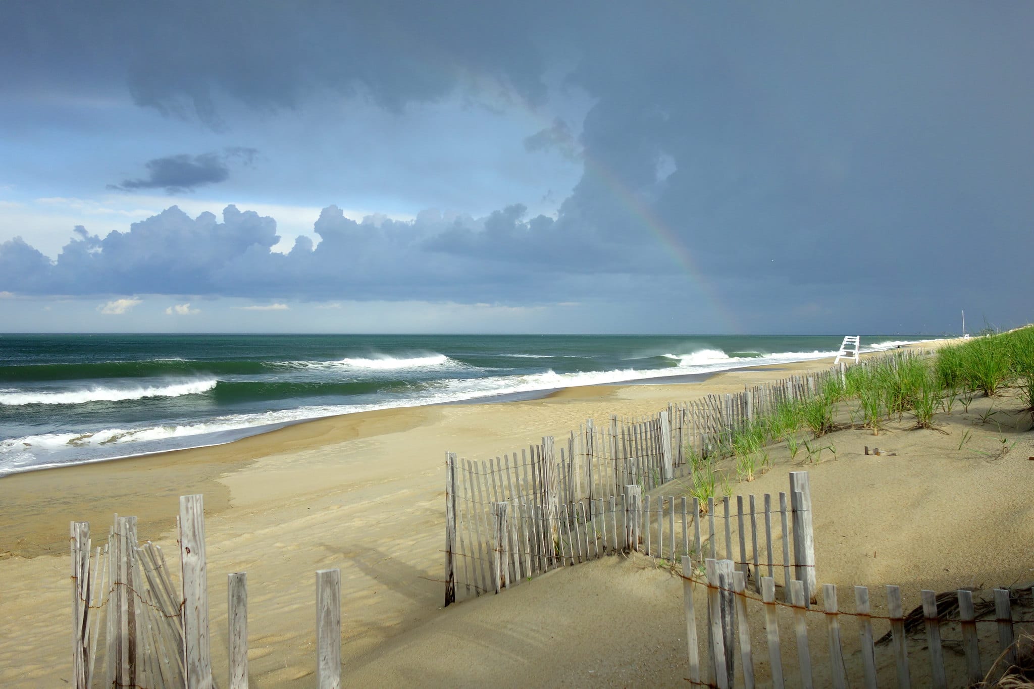 Remnants of a storm and a rainbow over Nags Head Beach in North Carolina